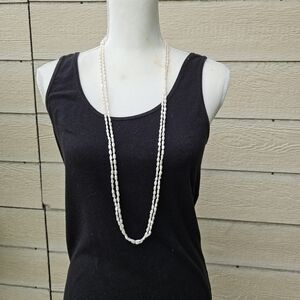 long double strand of rice pearls with gold tone floral clasp